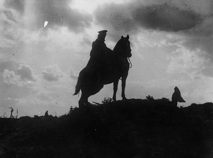 A_cavalryman_sitting_on_his_horse_on_a_ridge._Man_and_horse_are_black%2C_outlined_against_a_cloudy_sky._This_photograph_is_symbolic_of_the_last_days_of_the_use_of_cavalry_in_European_warfare._Trench_%284687939107%29.jpg